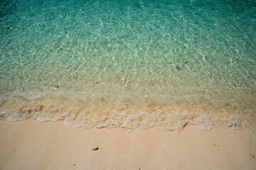 Clear ocean water in the sea with clean sand beach.