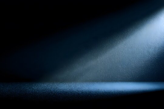 A dark blue beam of light shines against a black background, with nothing else in the frame. The texture of the material appears to be a soft, grainy film with a subtle gradient effect that gives an i