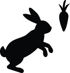 Obraz premium Black silhouette of a rabbit jumping towards a carrot isolated on transparent background
