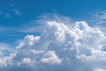 A vast expanse of cerulean blue sky filled with billowing, puffy white cumulus clouds