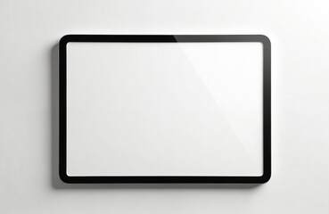 Blank black framed tablet rests against clean white wall background. Empty display screen offers versatile template for digital advertisement, presentation, graphic design needs. Modern device
