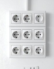 Multiple electrical outlets mounted on a white wall
