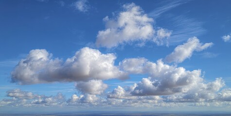 Obraz premium Vast blue sky dotted with puffy white clouds