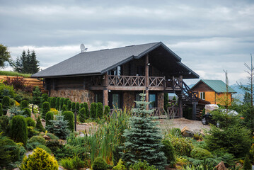 Rustic Cabin with Lush Garden and Cloudy Sky