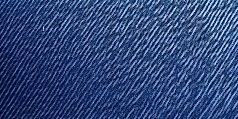 Close-up of dark denim fabric texture showing twill weave and worn areas,  rugged,  denim texture