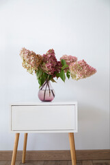 bouquet of hydrangea in  vase in white room