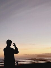 silhouette of a man watching the sunset