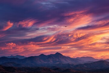 Obraz premium Dramatic sunset over mountains, with vibrant clouds