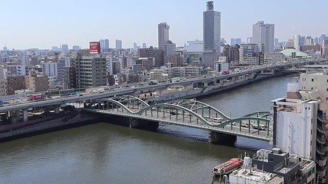View landscape building office tower architecture cityscape of Taito city with traffic road bridge crossing sumida river for japanese people travelers visit at Asakusa on July 21, 2025 in Tokyo, Japan