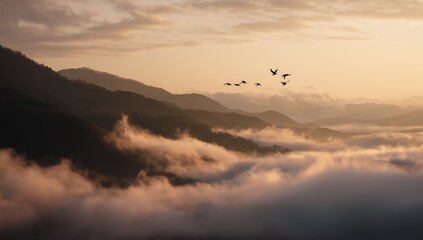 Obraz premium Distant sunrise over mountains with orange red sky and dramatic clouds, wide angle cinematic landscape view, flying bird above black hills, white fog and glowing horizon creating mysterious atmosphere