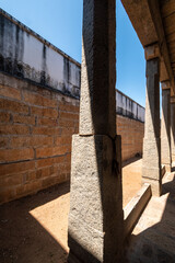 Light and shadows hitting the stone pillars of an ancient Hindu temple in the town of Kallidaikurichi in Tamil Nadu, India.