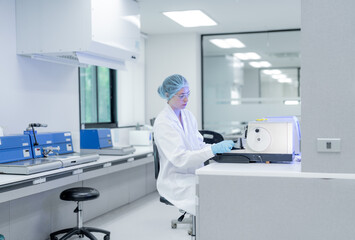 Laboratory technician conducts experiments in modern lab with advanced equipment in bright setting