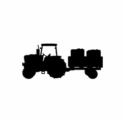 Silhouette of a tractor harvesting grapes in a vineyard