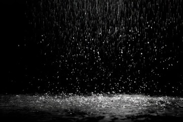 Heavy rain falling on dark surface
