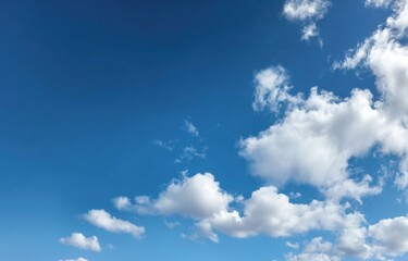 Fototapeta premium A vibrant blue sky filled with fluffy white clouds (1)