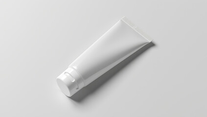 White plastic squeeze tube with flip cap on solid background