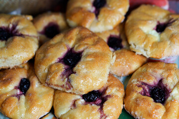 Freshly baked pastries with berry filling displayed at a local market in the afternoon sunshine