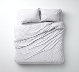 Top-down view of a pristine white bed with two pillows, and a rumpled duvet cover, isolated against a clean, bright white background
