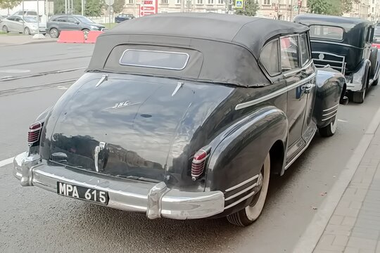 A classic black convertible ZIS-110 with vintage design and chrome details, parked on a city street - October 03, 2020, Saint Petersburg, Russia
