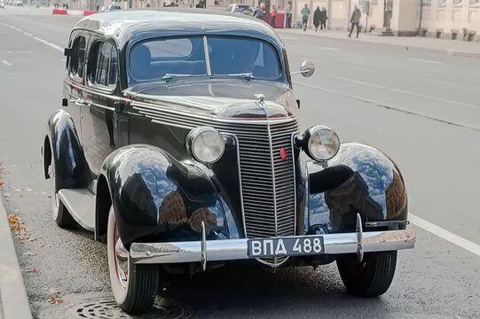 A beautifully preserved black vintage car ZIS-101 stands on an urban street - October 03, 2020, Saint Petersburg, Russia