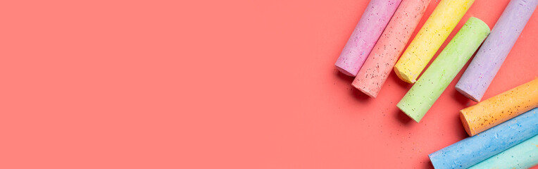Colored chalks for drawing on pink background flat lay top view. School chalks, back to school,...