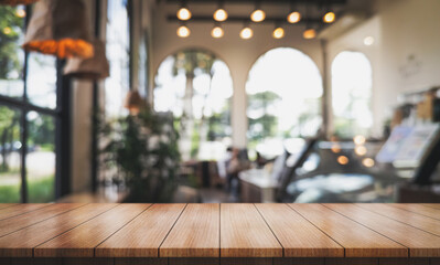 Empty wooden table top with lights bokeh on blur restaurant background.	