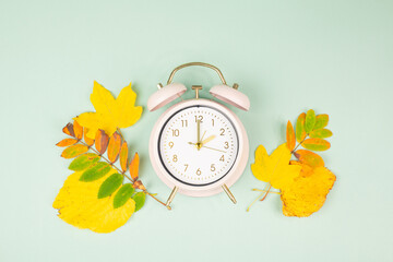Winter time changeover, end of daylight saving time in autumn, alarm clock fall back switch, colorful foliage, change season