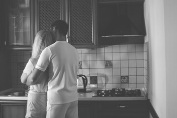 Lovely family enjoying breakfast together at their apartment. Spend Time With Significant Other. Cute family drinking coffee sitting in kitchen, looking at each other with love