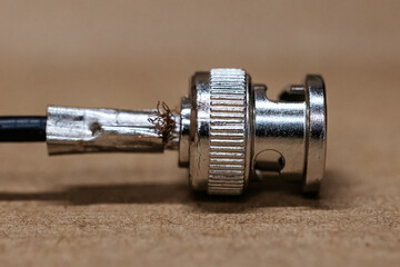 Macro photo of BNC connector. Metal connector with central contact, used for coaxial cables in video communication and radio equipment. BNC connector crimping.