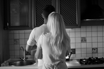 Lovely family enjoying breakfast together at their apartment. Spend Time With Significant Other. Cute family drinking coffee sitting in kitchen, looking at each other with love