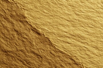 Close-up of gold-toned stone, textured surface with subtle ridges and angled planes