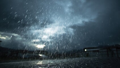 Heavy rain falls on a dark street