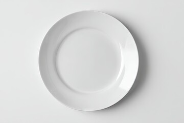 A pristine, oval-shaped, white porcelain plate rests on a plain white background, subtly shadowed at its edges, viewed from directly above