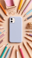 Pastel pencils form a circle around a lavender phone case on a beige background. A stapler and paper clips accent the arrangement