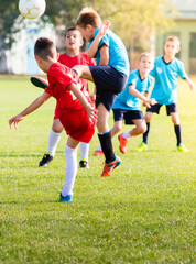 Obraz premium Boys kicking football on the sports field