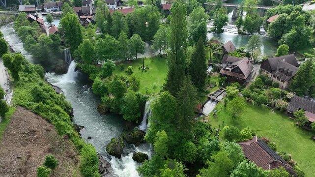 Watermill village Rastoke on rivers Slunj and Korana. Charming village of Rastoke with waterfalls, wooden houses, rivers running through. Aerial view of fairy-tale spring location in heart of Croatia