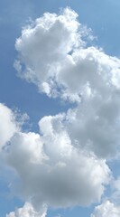 Bright, vertical view of fluffy, white cumulus clouds against a vibrant, clear blue sky. Evokes a sense of freedom and lightness on a sunny day