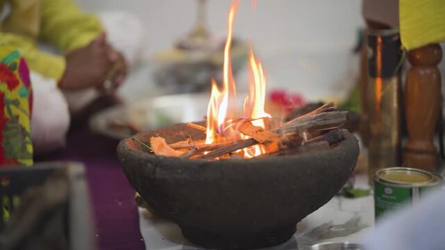 Sacred fire in havan ritual, Traditional hindu puja ceremony, Burning wood in worship ritual, Spiritual flame in religious offering stock video. 