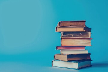 High Resolution of a Stack of Books with a Blue Background Behind Them