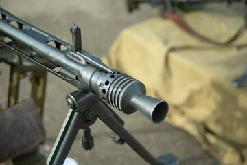 A machine gun for firing. Military weapons standing on the ground. Machine gun on the street.