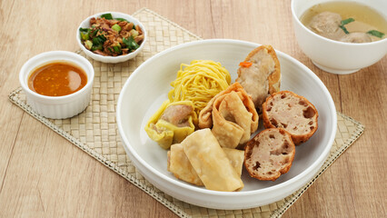 Bakso Malang, meatball soup with tofu, fried shumay, noodles and dumplings. Served with sambal and cucumber