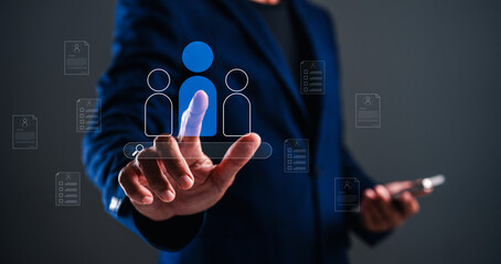 A professional individual interacts with digital icons representing people and documents, highlighting technology in business or networking.
