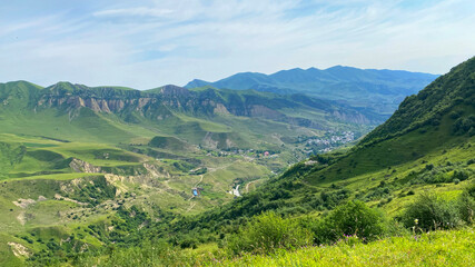 Trekking in the mountains of Azerbaijan. View from the height of the green slopes and mountain ranges. Beautiful green mountain valley