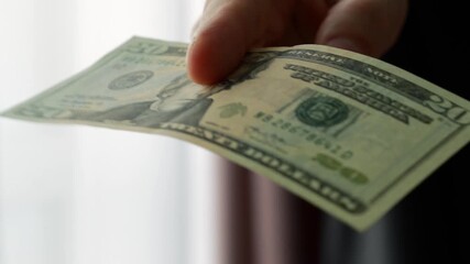 20 US dollars in the hands of a businessman.
Close-up of US 20 bills.
Businessman holding US money in his hands - Powered by Adobe