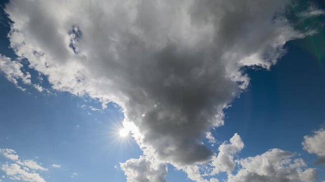 A Cloudy Sky Displaying Beautiful Sunlight Gently Peeking Through the Fluffy Clouds Up Above