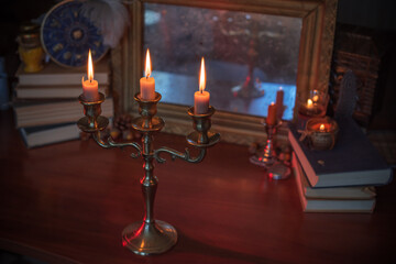 Candles burns on the altar, magic among candles, clean negative energy, wicca concept	