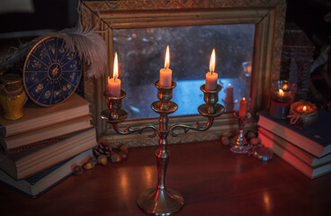Candles burns on the altar, magic among candles, clean negative energy, wicca concept	
