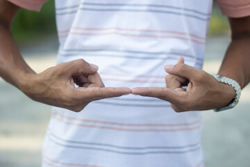 Mans hands showing a small gap between index fingers