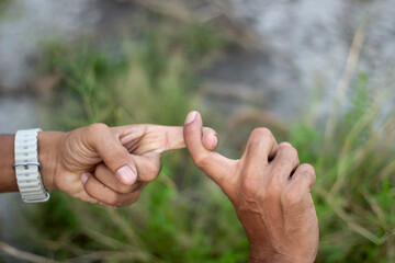 Two hands communicating through sign language, one finger touching another