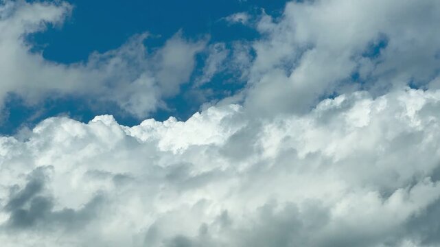 Fluffy White Clouds in a Bright Blue Sky After Rain.
